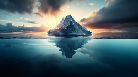 Split-level shot of iceberg, revealing massive underwater structure beneath surface