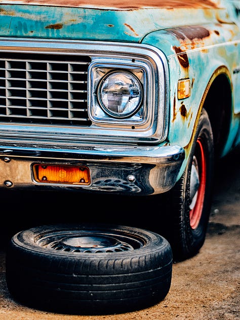 an old Chevy truck photographed through a fence