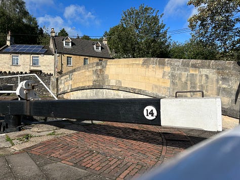 A lock with narrowboat on the Kennet and Avon Canal, Bradford on Avon. Another narrowboat moored on the bank. Images: Roland’s Travels 