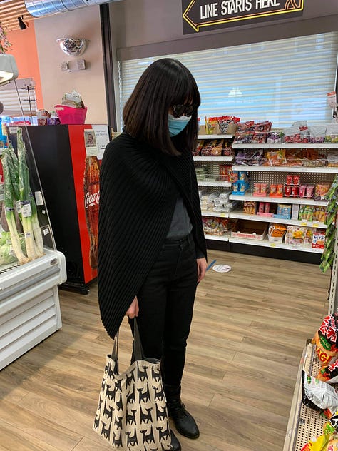 Left: Jenny in a blue sweater and dark jeans on a bike with some tulips. Center: Jenny in an all-black getup with sunglasses, a mask, and tote bag. Right: Jenny sitting outside in some cherry blossom pants and blue-gray sweater.