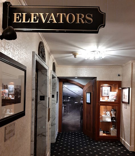 A collage of photos showing the Historic Hotel Bethlehem, including two photos of the 9-story brick exterior, and interior pictures of the elevators, white marble staircase with polished handrail, open doors to the ballroom with a glistening chandelier, and two photos of the lobby, with luxurious black leather furniture in front of a huge arched window with a Christmas wreath in the middle. Also a look inside a room of a bed with a robe lying on the end.