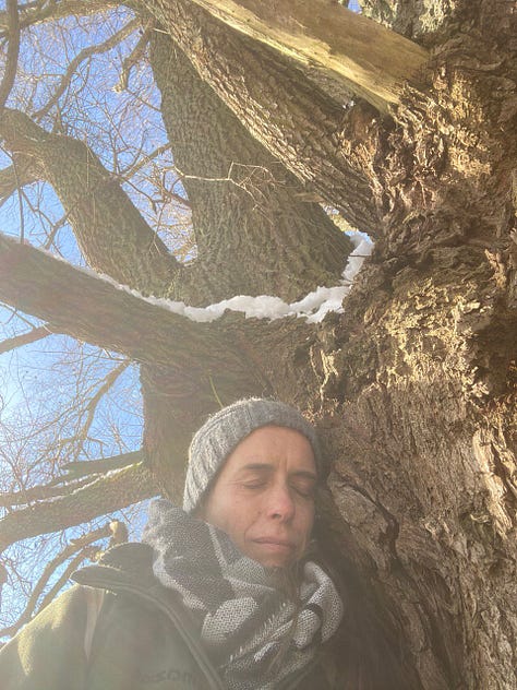 Kath leaning on to the trunk of her beloved Willow tree friend