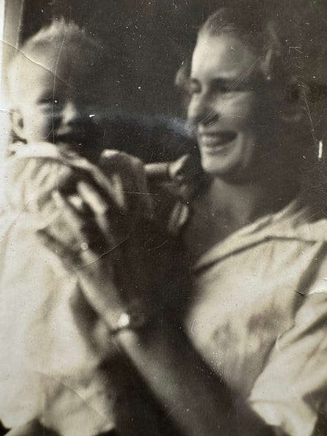 2 women in front of a liquor fridge, two women smiling bathed in pink light, two women smiling both with red lipstick on, notebooks on a table with the river in the background, jam and bowl of peaches, b&w photo of man playing the bango, b&w photo of woman smiling at a baby, two women smiling, two women smiling