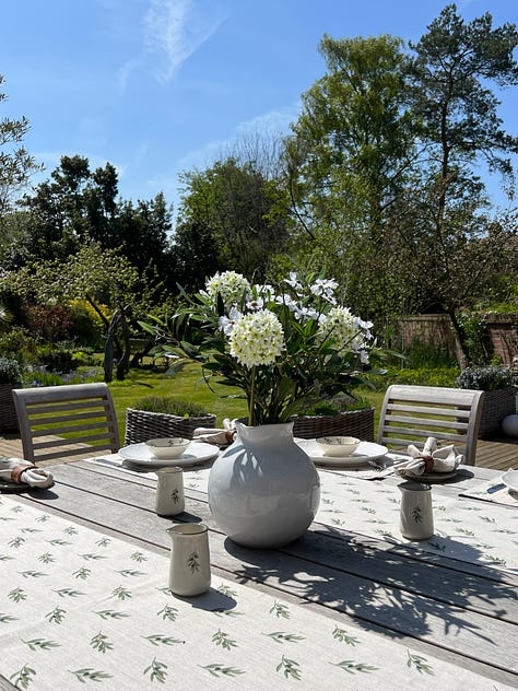 Utility room, garden canop, porch, verandah, flowers on a table in an English garden. 