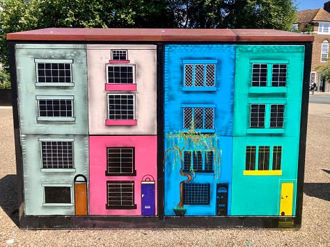 Street art - painted houses, a skeleton Mr Man and a man