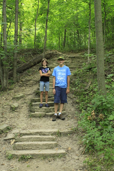 Photos of a heavily wooded trail with two people hiking and posing along the trail