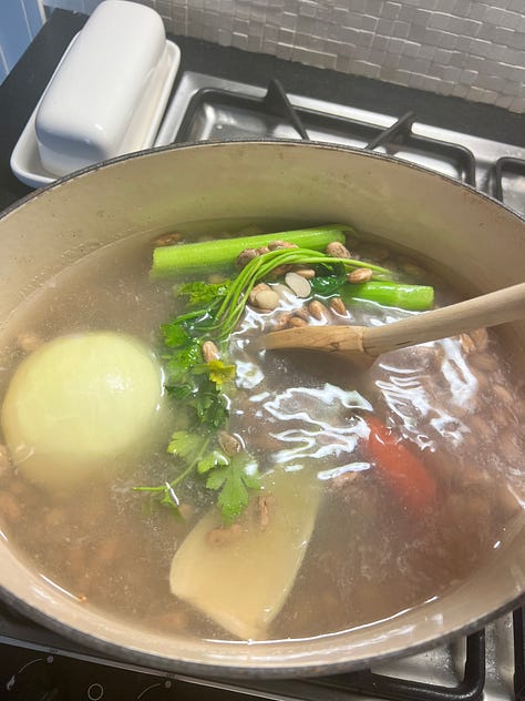 Beans in a pot with celery, carrots and onion to be cooked