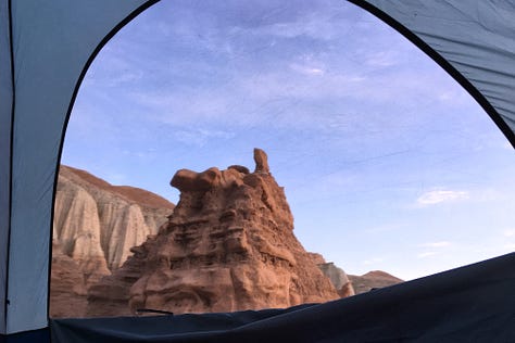 Three images of red rock hoodoos framed by the unzipped windows of a blue tent.