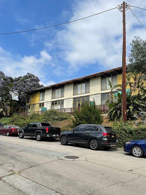 2040 Rodney Avenue, a midcentury modern apartment complex that has been empty for years and is suffering from deferred maintenance (mold, stucco damage, peeling paint, a long-empty pool, cracked concrete, rust stains, etc.).