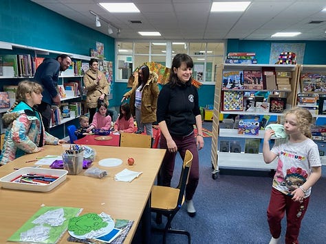 Children getting hands on in Ullapool LIbrary with Ranger Jenny