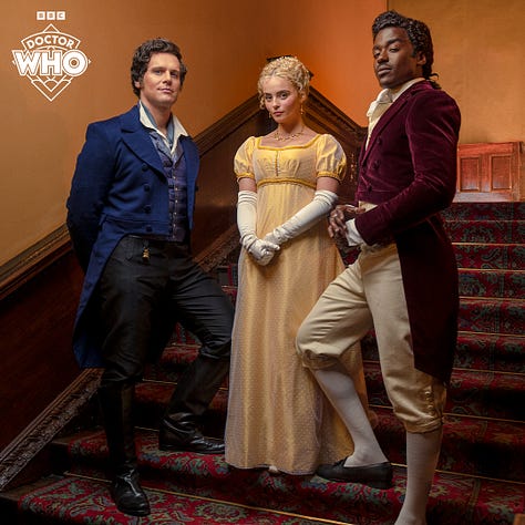 Pics 1 and 2 L-R: Jonathan Groff, Millie Gibson and Ncuti Gatwa on set for the upcoming series of Doctor Who. They are wearing regency-style clothing and standing together in the stairwell of an old manor. Pics 3-5 are additional pics of Gibson in a garden wearing a gold-coloured regency style dress with elbow-length white gloves.