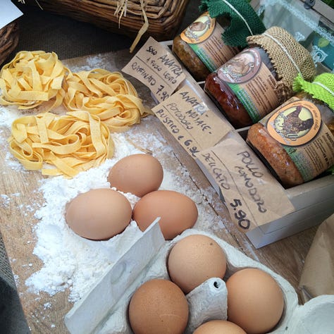 A selection of foods including eggs, cheese, nuts and people from past Terra Madre events