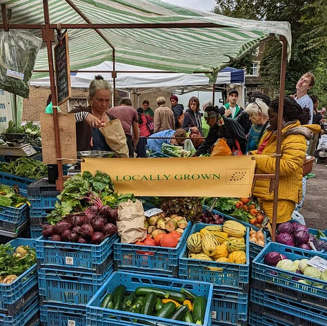 Growing Communities London veg box scheme, with images showing Mary one of the customers, the Stoke Newington Farmers' Market, and Millie Sandy's banner at Growing Communities' Clissold Park growing site.