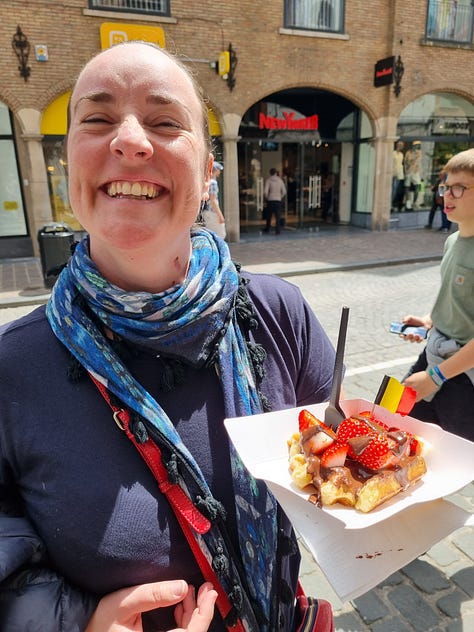 Photo 1: Dave appreciating dill chips. Photo 2: Aisling in front of an LED wings and halo. Photo 3: Dave reading a been menu. Photo 4: Image of Australia on the walls of the Antwerp Bourse. Photo 5: an inflatable blue whale in front of the Antwerp train station. Photo 6: Aisling grinning while holding a waffle. Photo 7: Dave holding two suitcases and two backpacks at Bruges station. Photo 8: Aisling lying on a pink bed interactive exhibit at the Moco museum. Photo 9: Aisling presenting a fountain with animals drinking from different beer cans in Utrecht.