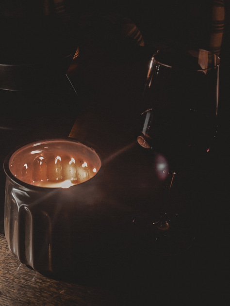 Dark moody pictures of candles, fireplace, books, and pizza