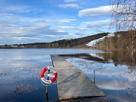 Sidsjön lake in Sundsvall shows ice, snow on the next-door hill and finally a lake clear of ice, two days later