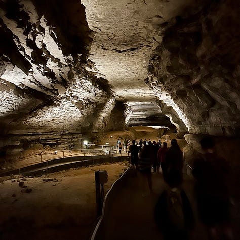 Three images show Nicole's trip into Mammoth Cave. In the first, a large group of people descend around 100 steps into the cave. In the second, the dimly lit Mammoth Passage is visible, with a group of tour-takers experiencing the view. In the third image, Nicole's pink Vans slip-ons step on a sudsy, black mat.