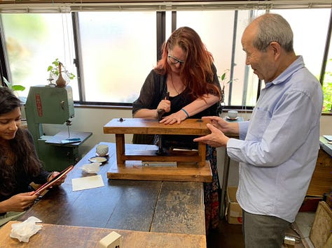 A series of images that show a person being taught how to stitch and glue paper to make a notebook