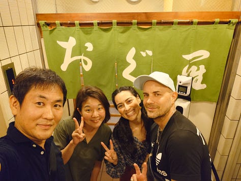 9 pictures of Jackson, his wife, his Japanese cousin, Eikichi, and Eikichi's wife, Megumi, together, visiting the ancestral grave in Iyo City, walking around Matsuyama, eating dinner with Uncle Kazuya, leaving the train station, eating Oden in Ginza, posing with Lin-Chan, the Japanese poodle, and pictures of Jackson and Erika taking pictures of the Tokyo skyline