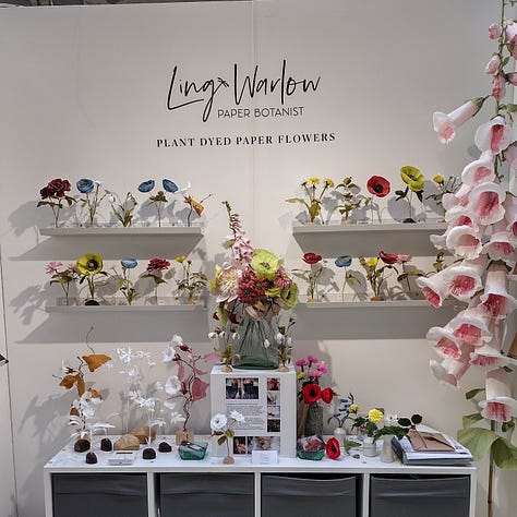 Images of my stand at Great Northern Contemporary Craft Fair, Victoria Baths, Manchester. The walls are white with colourful,paper wildflowers on shelves and a giant paper foxglove in one corner.