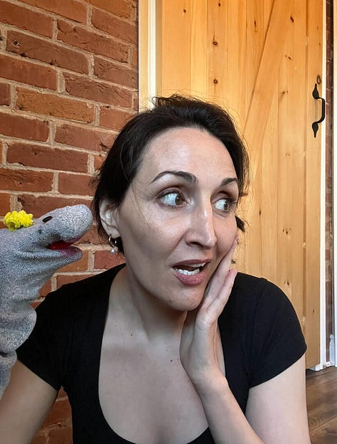 Hollay Ghadery holding a grey sock puppet