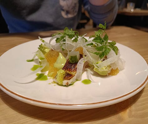 three images of plates of food, one of roasted reindeer, a dessert of cloudberries and a cured fish dish garnished with herbs