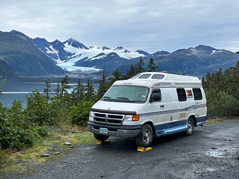 A picture of a white van next to the ocean, a picture of Liz inside a glacial ice cave, a picture of sandhill cranes on the beach in Alaska