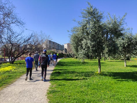 Participants on the route, plus a barren hard-packed surface under the playground