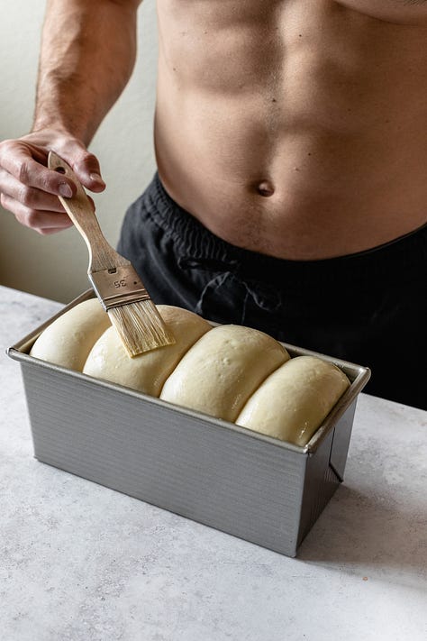 Shirtless baker in black pants making vegan milk bread loaves