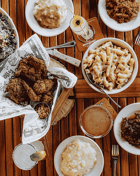 3 photos from L to R: external photo of Zingerman's Roadhouse Restaurant; bowl of mac & cheese; table with fried chicken and bowl of mac & cheese