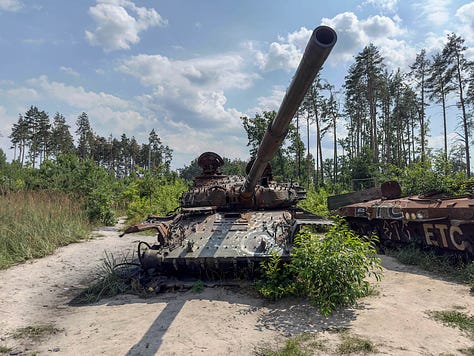 Destroyed residential buildings and school in Chernihiv; Bullet holes in a bust of Taras Shevchenko at Borodyanka; a Russian tank graveyard north of Kyiv; and village scene at Yahidne.