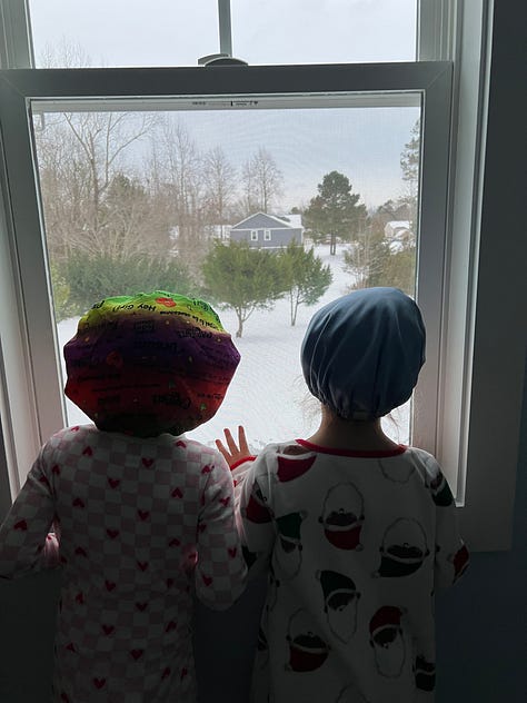 toddler holding blue nyon 2 balloon, 2nd birthday cake, a snippet from FURY, snow falling near a street lamp, kids looking at snow through the window, snow