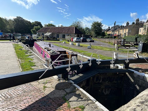 A lock with narrowboat on the Kennet and Avon Canal, Bradford on Avon. Another narrowboat moored on the bank. Images: Roland’s Travels 
