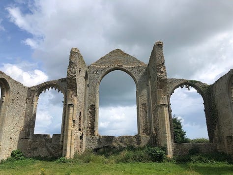 Three photographs of the ruin of Covehithe church. In the third photo, Ed is standing in front of the smaller church inside the ruin.