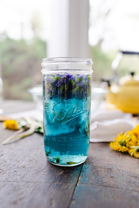 Cookies pressed with wild violets, basket of wild violets and dandelions