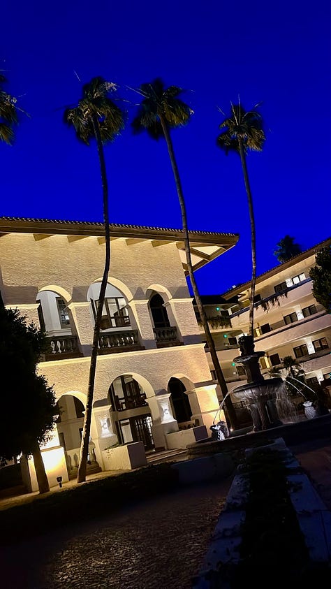 Sky and white stucco buildings in the evening and night