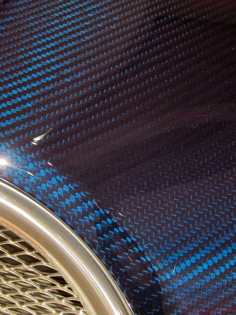 close up photo of Bugatti Veyron carbon fiber laquer finish