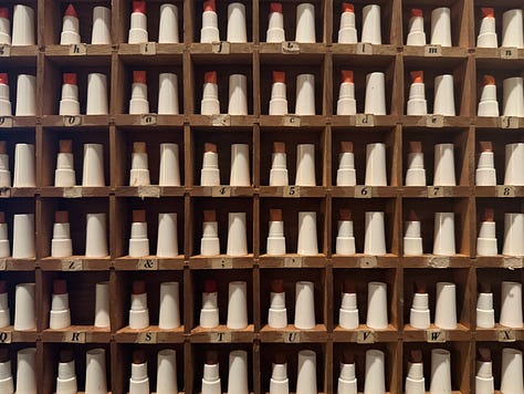 Image of lipstick samples in a wooden wall box. A black-and-white of Step at the pool.