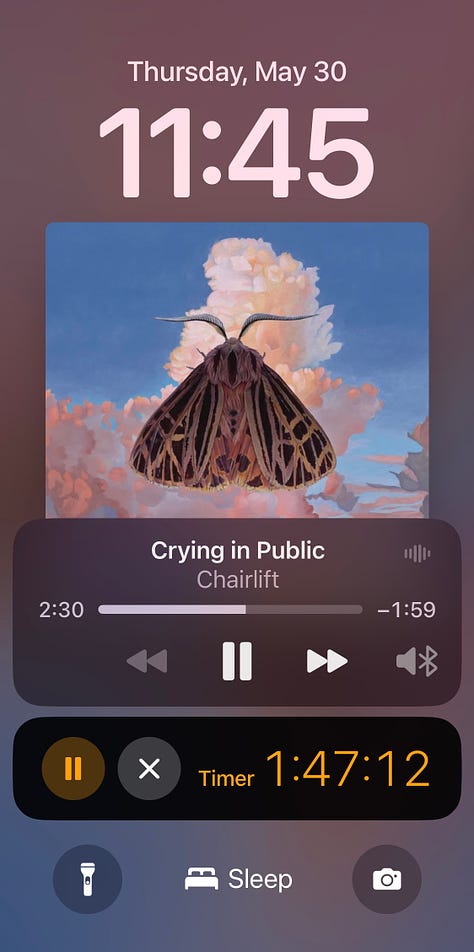 A screenshot of my new Cara account, screenshot of the Chairlift song "Crying in Public" playing on my phone, and my hand holding up my mustard yellow art supply bag