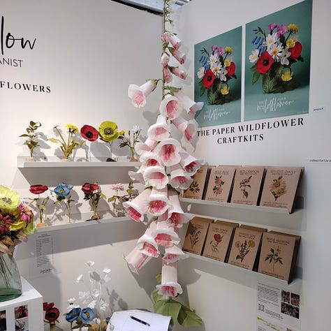 Images of my stand at Great Northern Contemporary Craft Fair, Victoria Baths, Manchester. The walls are white with colourful,paper wildflowers on shelves and a giant paper foxglove in one corner.