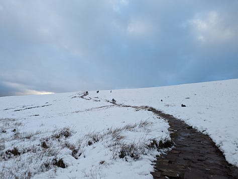 Sunset walk on Pen y Fan in winter with snow 