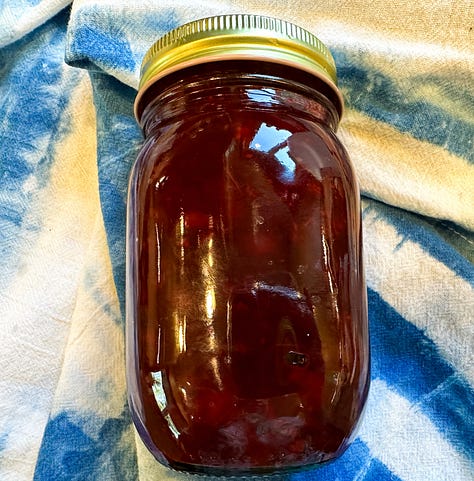 cranberries in a sauce pan cooking and then canned ready for Thanksgiving