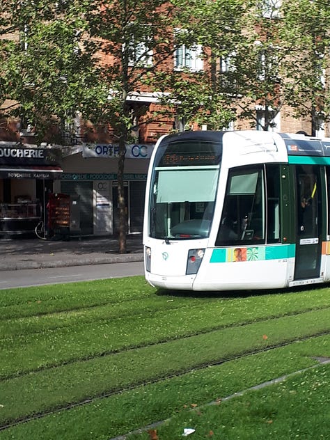 Images of LRT tracks amid grass, with an LRT train approaching.