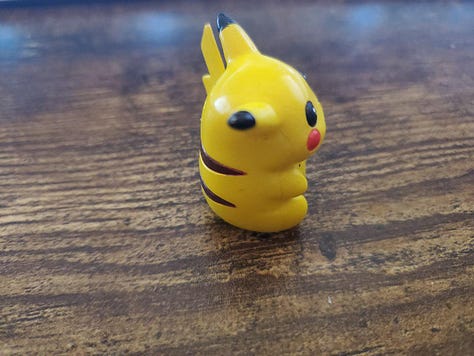 A selection of photographs from Shayne Roberts of his Pikachu Pencil Topper, and framed shirt