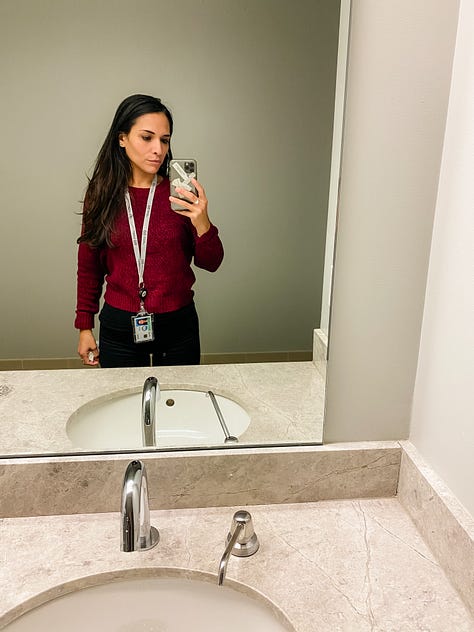 Mirror selfie photo of woman in an elevator wearing a mask and social distancing markers on the floor of the elevator, mirror selfie of a woman, mirror selfie of a woman