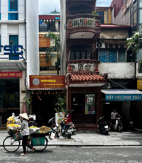 the Religion Publishing House, a pho stand, people cooking meat on the street for banh mi and bun cha, and Craft Link, a social enterprise shop encouraging economic development and helping rural women support themselves by "seeking new markets for traditional artisans."    