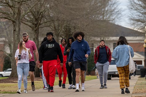 Students walk across the Troy campus heading to class