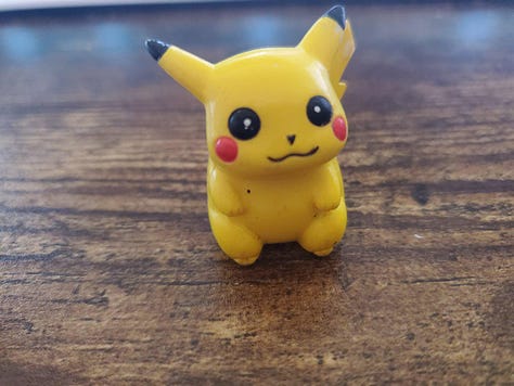 A selection of photographs from Shayne Roberts of his Pikachu Pencil Topper, and framed shirt