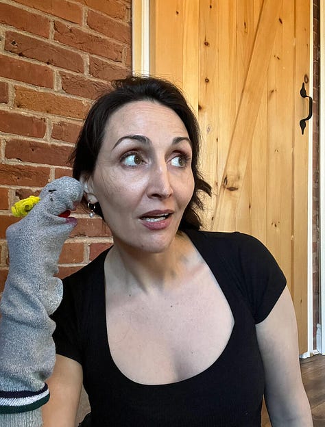 Hollay Ghadery holding a grey sock puppet