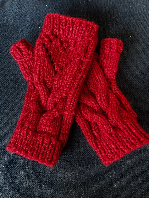 Red fingerless mitts with a cable design, marled blue, blue and lavender cowl, blue and white headband/earwarmer